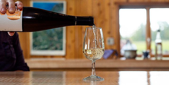 Our Tastings Poring glass of white wine